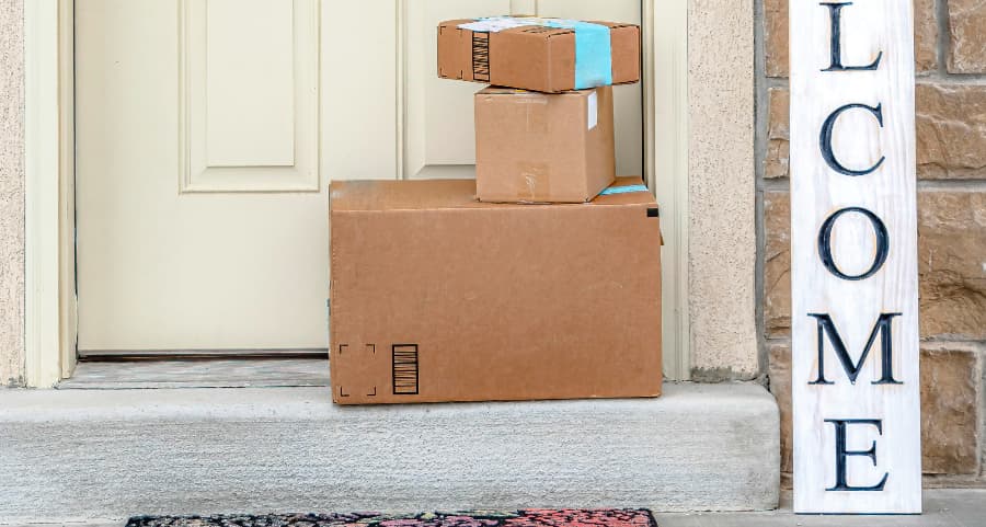 Boxes by the door of a residence with a welcome sign in Orlando